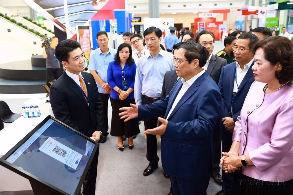 La transformación digital es un requisito y una tendencia inevitable y objetiva para que la comunidad empresarial vietnamita se mantenga firme y se desarrolle. En la foto: El primer ministro Pham Minh Chinh visita una muestra sobre la aplicación de la transformación digital en el sector bancario (8 de mayo de 2024). (Fuente:VNA)