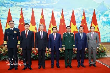 El primer ministro de Vietnam, Pham Minh Chinh, (cuarto a la derecha) recibe a los ministros chinos. (Fuente: VNA)