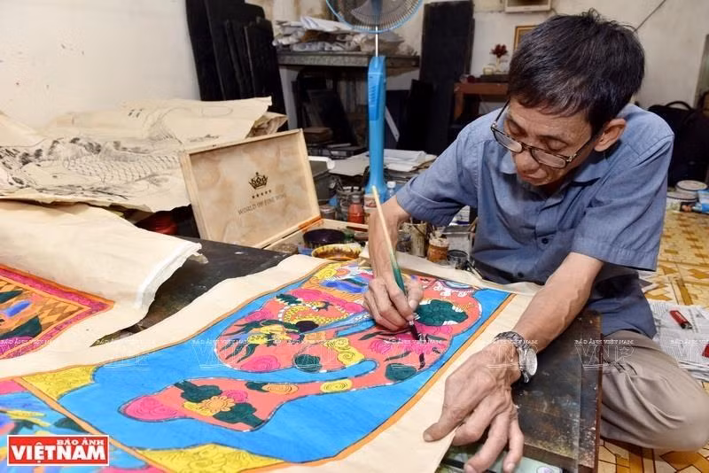 Le Dinh Nghien es reconocido como el último artista en pintar con bloques de madera en Hang Trong, una antigua calle cerca del lago Hoan Kiem, en el centro de Hanoi. (Foto: VNA)