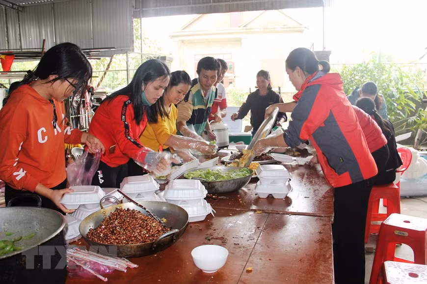 Residentes en el municipio de Thach Ha participan en la elaboración de alimentos para donar a los compatriotas afectados por las riadas (Fuente: VNA)