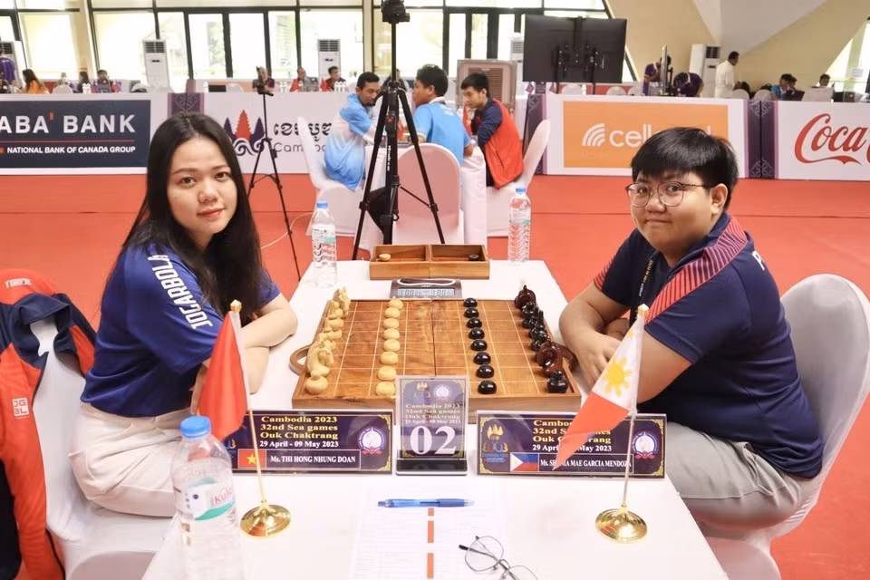 La jugadora vietnamita Doan Thi Hong Nhung (izquierda) obtuvo una medalla dorada al vencer a Shania Mae García Mendoza (Filipinas) en el partido de vuelta de la ronda final de Ouk Chaktrang, un tipo de ajedrez khmer en los SEA Games 32 (Fuente: VNA)