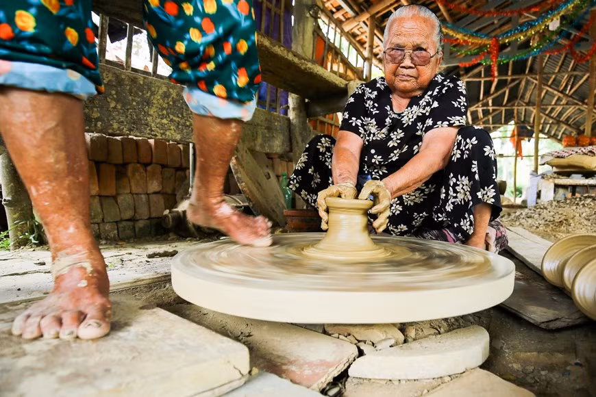Durante 5 siglos, hasta ahora, los artesanos de la aldea de Thanh Ha siguen conservando el método tradicional de producción único y manual: crean las formas utilizando las manos o platos giratorios de pie, sin moldes. El proceso de preparación de la arcilla (para dar forma a los productos) requiere a dos artesanos, de ellos uno se sustenta sobre un pie mover el plato giratorio, mientras que el otro usan las manos para modelar la arcilla. (Foto: Vietnam +)