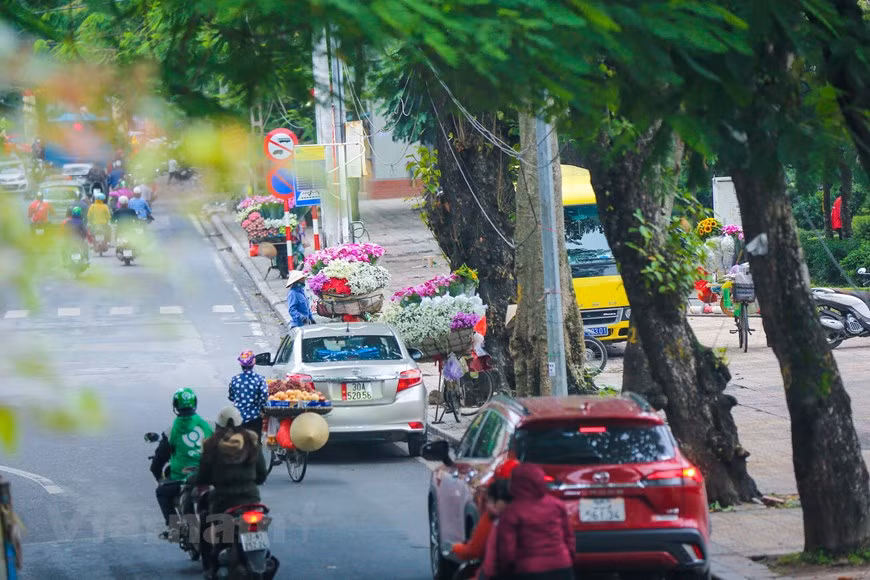 Las vendedoras ambulantes o callejeras las que embellecen y dan vida a la capital, pedaleando algunas sus bicicletas frente a las que los visitantes quedan atónitos al ver las “montañas” de productos que cargan, o ante sus cestas repletas de frutas y vegetales, sujetas a ambos lados por un palo que logran estabilizar como el más diestro de los equilibristas. Con sus hábiles manos son capaces de pelar y dar formas atractivas a decenas de frutas que endulzan el paladar aun sin probar bocado, elaboran hermosos ramos de flores o preparan un delicioso café o té que se agradece en las mañanas. (Foto: Vietnam+)