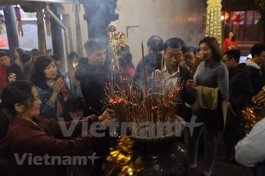 En el momento de la entrada del año nuevo lunar o el Tet en vietnamita, los visitantes acuden a las pagodas para rendir tributo al Buda y pedir suerte y fortuna por un año prospero. Visitar las pagodas se ha convertido en una actividad espiritual de los pobladores de Hanoi que llegan para orar por un año lleno de felicidad, alegría y prosperidad. La pagoda de Ha en esta ciudad ha pasado por muchos años de altibajos y la actualidad aún conserva su belleza superficial. Este es un lugar famoso entre los jóvenes, especialmente los solteros que vienen para orar por amor. (Foto: Minh Son/Vietnam+)