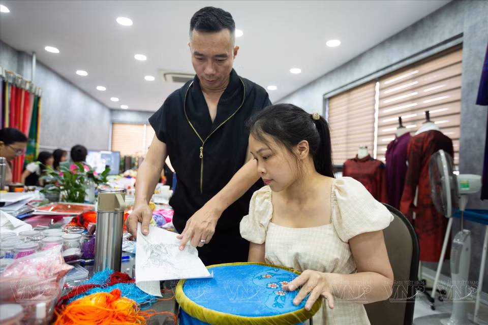 Hoai Nam habla con el personal sobre cómo colocar patrones en la tela. Foto: Revista Vietnam