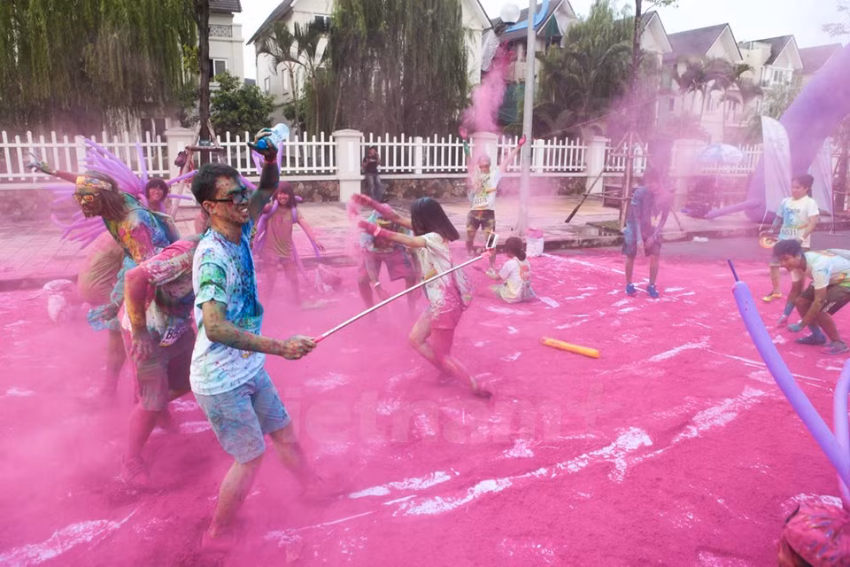 Un desafío para los participantes: embardunarse en un montón de polvo, y sólo pudieron continuar la carrera una vez manchado todo el cuerpo con color. (Fuente: VNA)