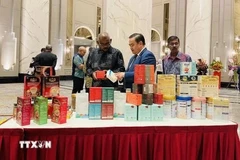 El consejero comercial vietnamita en Malasia, Le Phu Cuong (en el centro), presenta productos tradicionales vietnamitas a los invitados. (Fuente: VNA)
