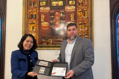 El diputado Víctor Aldaya entrega a la embajadora de Vietnam en Aregentina, Ngo Minh Nguyet, un juego de sellos emitidos por Correos del Uruguay en diciembre de 2013, en conmemoración del 20.º aniversario de las relaciones diplomáticas entre Vietnam y Uruguay, con el retrato del General Vo Nguyen Giap. (Fuente: VNA)