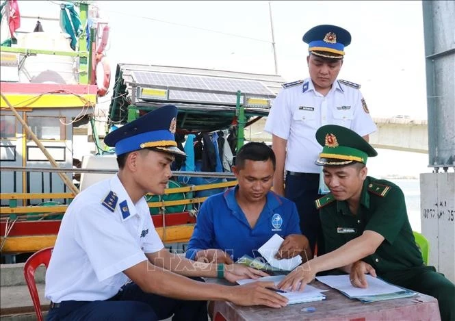 Las autoridades pertinentes movilizan a los pescadores a firmar un compromiso para combatir la pesca ilegal en el puerto pesquero de Cua Viet. (Foto: VNA)
