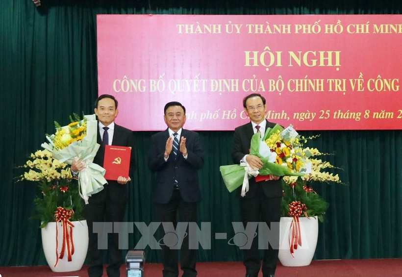 El miembro del Buró Político y permanente del Secretariado del Comité Central del PCV, Tran Cam Tu, entrega las decisiones del Buró Político a Tran Luu Quang y Nguyen Van Nen (Foto: VNA)