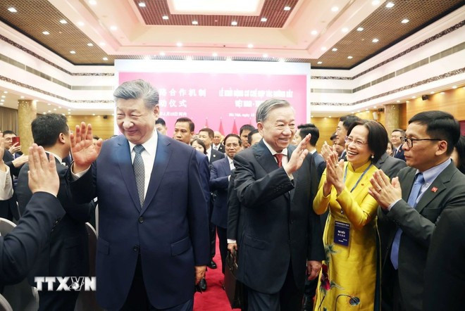 El secretario general del Partido Comunista de Vietnam, To Lam (derecha), y el secretario general del Partido Comunista de China y presidente ese país, Xi Jinping, saludan a los delegados asistentes al Festival de Intercambio Amistoso entre los dos pueblos (Foto: VNA)