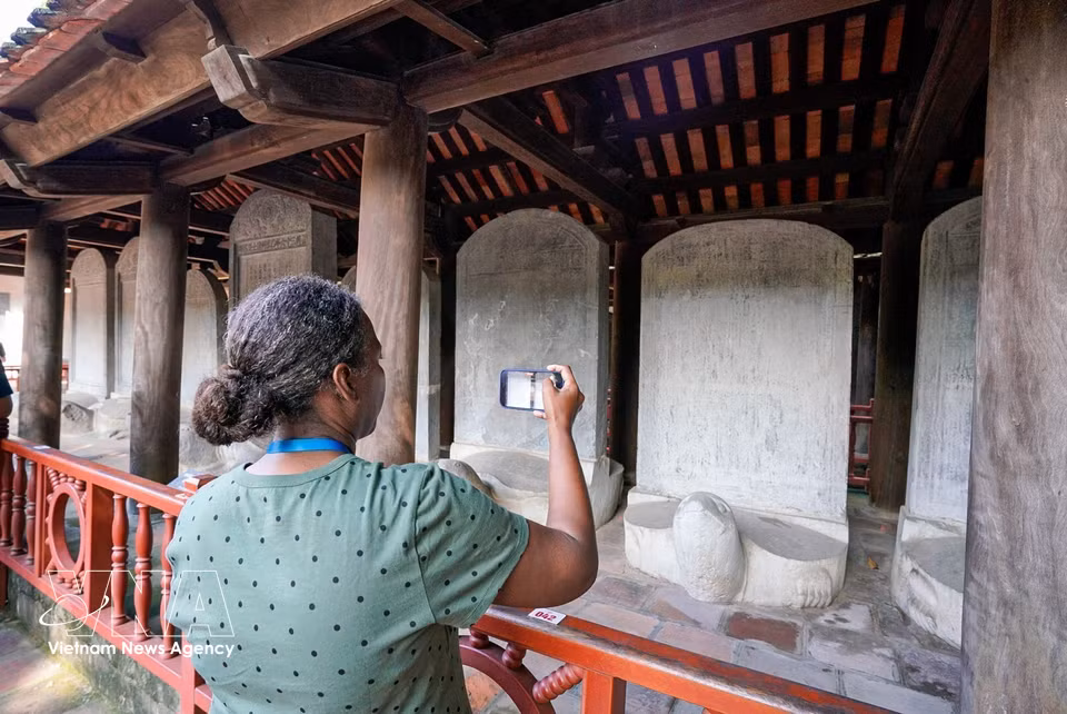 Los delegados conocen los valores históricos y culturales del Templo de la Literatura. Foto: VNA