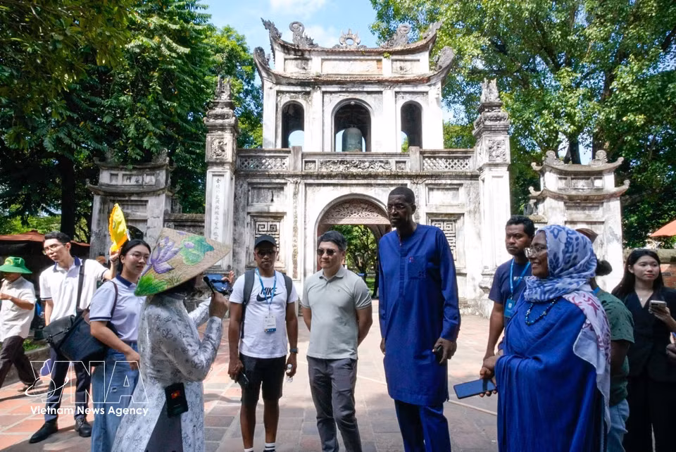 Los delegados conocen los valores históricos y culturales del Templo de la Literatura. Foto: VNA