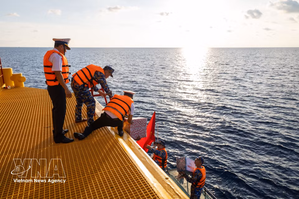 Los obsequios enviados desde tierra firme son trasladados a la plataforma. (Foto: VNA)