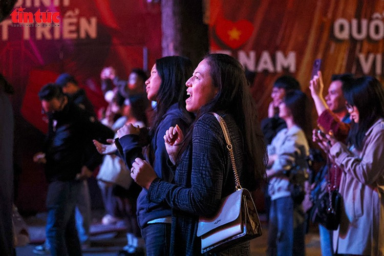 Muchos turistas extranjeros se detuvieron para sumarse al ambiente emocional del festival. (Foto: VNA)
