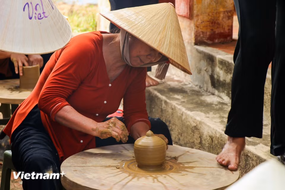 Un artesano da forma rítmicamente a la arcilla sobre un torno tradicional, accionado solo con la fuerza de sus pies. (Foto: Vietnam+)