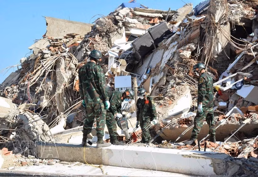 Los rescatistas vietnamitas trabajan para llegar hasta las víctimas atrapadas bajo los escombros. (Foto: VNA)