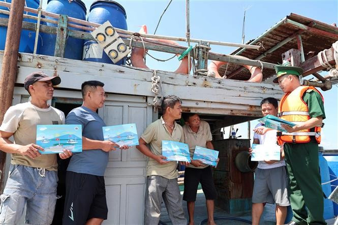 Oficiales y soldados de la Estación de Guardia Fronteriza de Son Tra (Comando de la Guardia Fronteriza de la ciudad de Da Nang) informan a los pescadores de embarcaciones otras provincias que anclan para evitar tormentas en la puerta marítima de la ciudad. (Fuente: VNA)