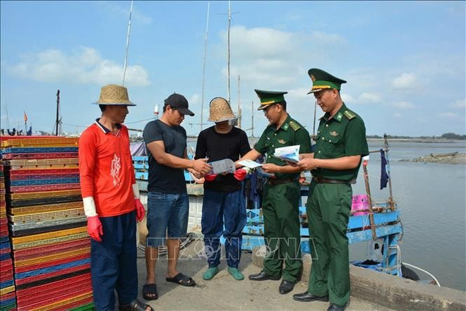 Oficiales de la estación de guardia fronteriza de Phuoc Tinh difunden información sobre la lucha contra la IUU a los pescadores (Foto: VNA) iuu-290725.jpg