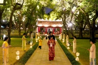 Turistas disfrutan del recorrido nocturno "Sonidos de Vietnam" en el Templo de la Literatura. (Foto: hanoimoi.vn)