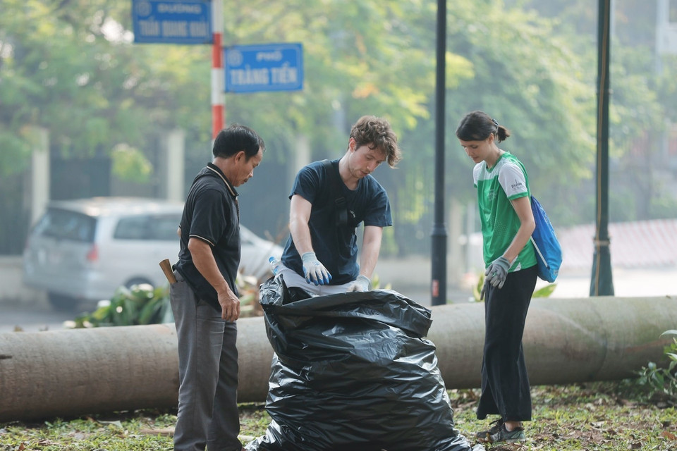 Los voluntarios recogen basura en la zona del jardín de flores de Bac Co (distrito de Hoan Kiem). (Foto: VNA)