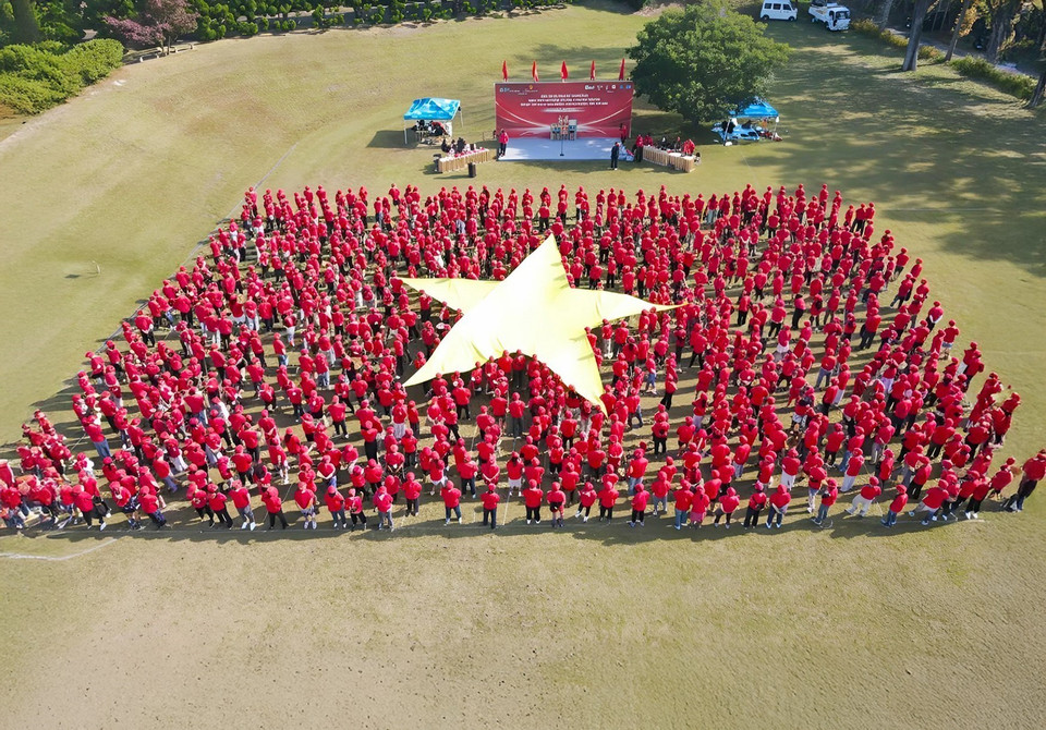 Imagen de la bandera de Vietnam formada por 15 bloques que representan a 15 componentes de la comunidad, con más de 1.000 participantes. (Foto: VNA)