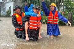 Fuerzas militares rescatan a un residente de una zona inundada. Foto: VNA