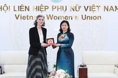 Nguyen Thi Tuyen, vicepresidenta del Comité Central del FPV y presidenta de la Unión de Mujeres de Vietnam, entrega un obsequio a Ramla Khalidi, representante residente del PNUD en el país (Foto: VNA)