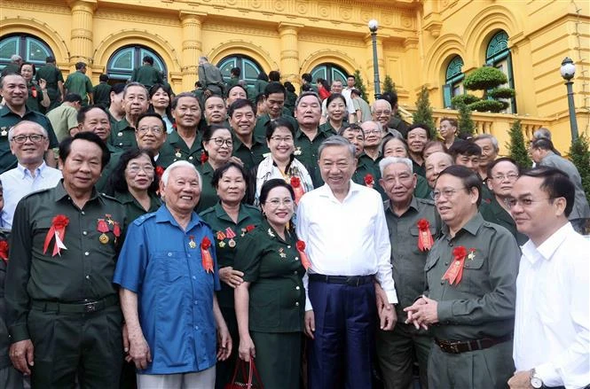 El presidente vietnamita, To Lam, y los exjóvenes voluntarios (Foto: VNA)
