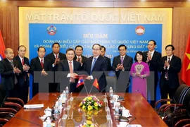 Organizaciones de masas de Vietnam y Laos robustecen cooperación