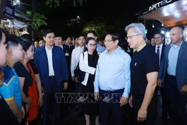 El primer ministro vietnamita, Pham Minh Chinh, y el fundador y presidente del gigante tecnológico NVIDIA, Jensen Huang, se reúnen con pobladores y turistas. (Fuente: VNA)