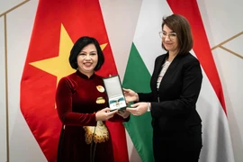 La secretaria de Estado de Relaciones Bilaterales del Ministerio de Asuntos Exteriores y Comercio Exterior de Hungría, Illés Boglárka, entrega la Cruz de la categoría de Oficial de la Orden del Mérito a la embajadora vietnamita en Budapest, Nguyen Thi Bich Thao. (Fuente: VNA)