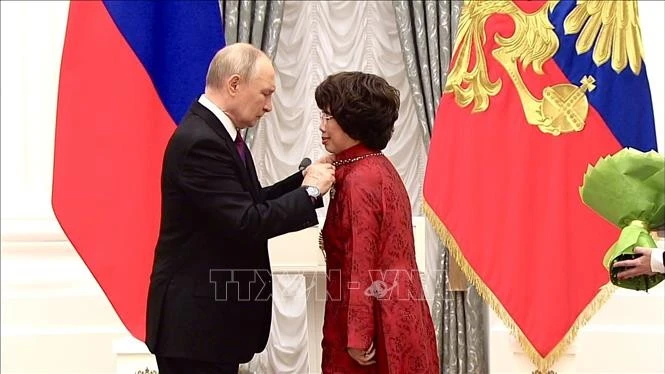 Thai Huong, presidenta del Consejo de Estrategia del gigante lácteo vietnamita TH Group, recibe la Orden de la Amistad de manos del presidente ruso, Vladimir Putin. (Foto: VNA)