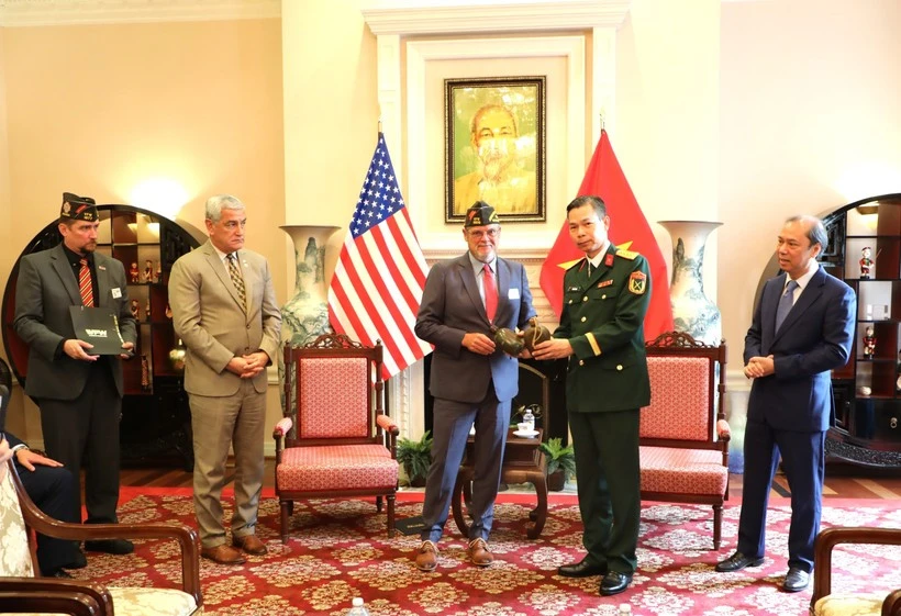 Un representante de la VFW (izquierda) entrega recuerdos de la guerra a la parte vietnamita. (Foto: VNA)