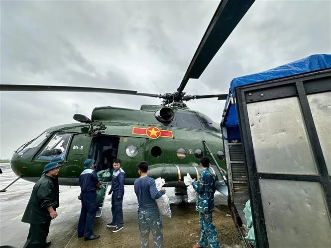 La ayuda de emergencia se carga en un helicóptero para ser enviada a los residentes aislados por las inundaciones. (Foto: VNA)