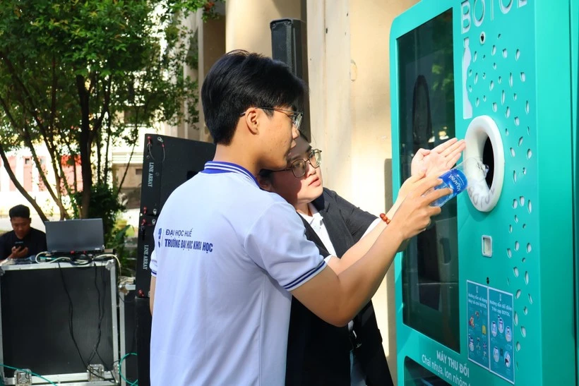 La gente experimenta el modelo “Depósito y Retorno”. (Foto: VNA)