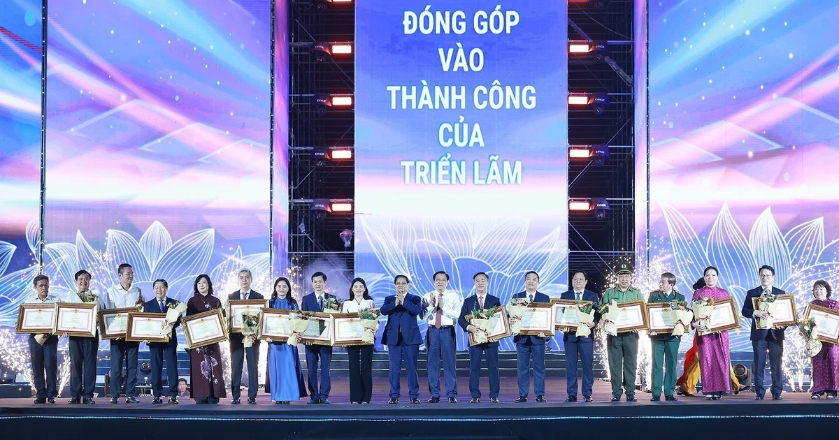 El primer ministro de Vietnam, Pham Minh Chinh, otorga certificados de mérito a colectivos e individuos con logros destacados en la organización de la exposición (Foto: VNA)