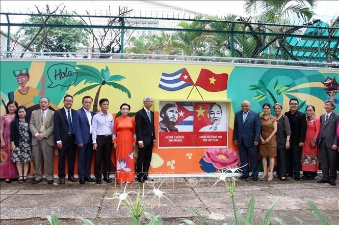 Los delegados posan para una foto frente al mural. (Foto: VNA) 