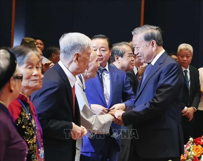 El secretario general del Partido Comunista de Vietnam, To Lam, saluda a las personas con méritos revolucionarios (Foto: VNA)