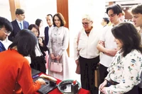 Los turistas extranjeros disfrutan al experimentar la impresión de xilografías. (Fuente: nhandan.vn)