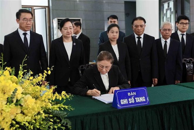 La vicepresidenta de Laos, Pany Yathotou, escribe en el libro de condolencias del expresidente estatal Tran Duc Luong. (Foto: VNA) lao.jpg