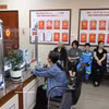El modelo de gobierno local de dos niveles ha recibido la aprobación y satisfacción de la población y las empresas. Foto: VNA