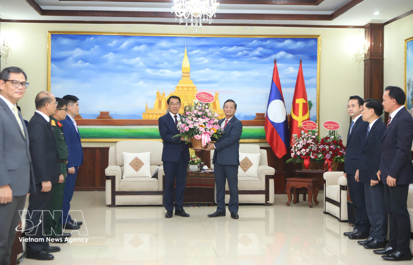 El embajador Nguyen Minh Tam entrega las flores del secretario general del Partido, To Lam, a la Comisión de Relaciones Exteriores del Comité Central del PPRL para felicitar al partido por su 71.º aniversario de fundación. (Foto: VNA)