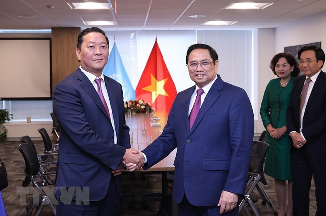 be El primer ministro de Vietnam, Pham Minh Chinh (en la derecha) y Joseph Bae, director ejecutivo del Fondo de inversión Kohlberg Kravis Robert (Fuente: VNA) Proponen a grandes grupos de EE.UU. apoyar a Vietnam en desarrollo sostenible ảnh 1