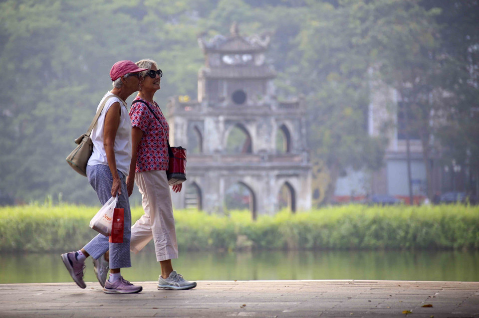 Turistas foráneos pasean por el lago Hoan Kiem. (Foto: VNA)