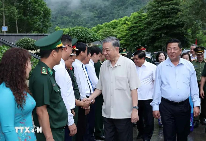 El presidente de Vietnam, To Lam (de camisa gris claro), y representantes de las autoridades y fuerzas pertinentes en el el Área de Reliquias Nacionales Especiales de Pac Bo. (Fuente: VNA) 3.webp