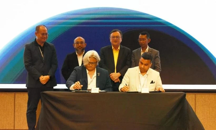 Sudarnoto (izquierda) y Arun firman el memorando de entendimiento. (Foto: the borneopost)
