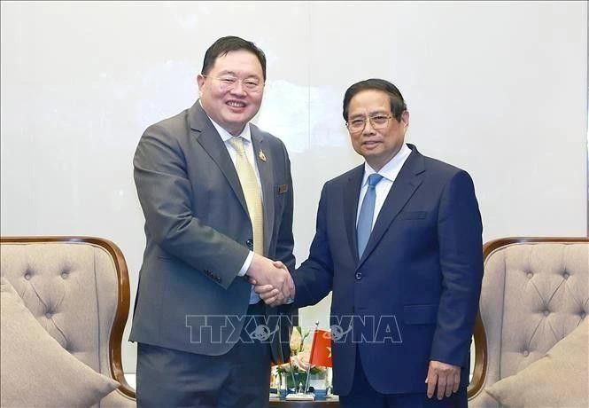 El primer ministro Pham Minh Chinh (der.) recibe a Thammasak Sethaudom, presidente y director ejecutivo de SCG Group. (Foto: VNA)