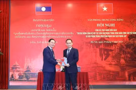 El secretario del Comité Central del PCV y jefe de su Oficina, Le Hoai Trung (derecha), y su similar del PPRL, Thongsalith Mangnomek (Foto: VNA)
