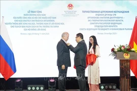 El embajador de Vietnam en Rusia, Dang Minh Khoi, entrega la Orden de la Amistad a Anatoli Dmitrievich Artamonov (izquierda), presidente del Comité de Presupuesto y Mercados Financieros del Consejo de la Federación y exgobernador de la región de Kaluga. (Foto: VNA)